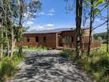 The north elevation is more enclosed, providing enclosure and refuge to the rear of the house. Native plants have sprung back to life and help control storm water flowing down the mountain from above, as it courses through the site. 