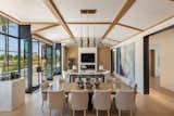 Dining Room, Two-Sided Fireplace, Pendant Lighting, Table, and Light Hardwood Floor Living Room to Fireplace  Photo 7 of 19 in Mountain Shadows by Catalano Architects