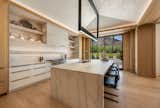 Kitchen, Marble Counter, Light Hardwood Floor, Stone Slab Backsplashe, Pendant Lighting, and Drop In Sink Kitchen Island   Photo 10 of 19 in Mountain Shadows by Catalano Architects