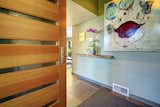 Beautiful entryway with modern wood door and slate flooring.