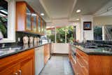 The kitchen with a garden view and beautiful cherry wood cabinetry.