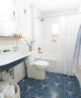 This chic, dual-trough sink with geometric tile is a showstopper in this guest bath.