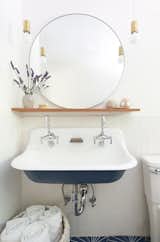 This sophisticated, yet highly functional dual-trough sink is a focal point in this guest bathroom.