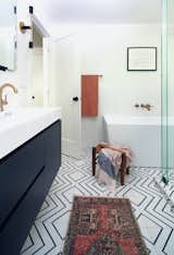Clean lines and beautiful black + white flooring provides a bold statement in this primary en-suite.