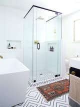 Swoon over this beautiful shower and soaking tub with bold black + white flooring!