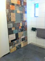 Stone wall in accessible open shower bathroom