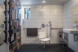 Roomy accessible bathroom with multiple shower heads and shower seat.