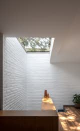 Hallway and Medium Hardwood Floor Skylight and stairs  Photo 10 of 17 in R.A House by Estudio Radillo Alba