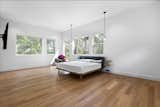 Bedroom, Bed, Light Hardwood Floor, Pendant Lighting, Recessed Lighting, and Chair  Photo 16 of 44 in The Red Cabin by Maureen Rivas