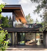On the second level, a glass-lined terrace overlooks the backyard. 