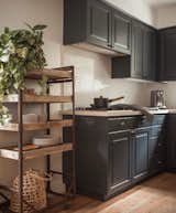 Refreshed kitchen with bright, refinished wood floors and slate blue/grey cabinets.