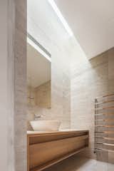 Bath Room, Stone Counter, Recessed Lighting, Travertine Floor, Open Shower, One Piece Toilet, Vessel Sink, and Stone Tile Wall  Photo 14 of 16 in House R by Jakub Kolarovič Architects
