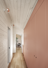 Sleek cabinet doors conceal storage and a stacked laundry unit. For the hallway lighting, Blair paired standard ceramic light fixtures with copper-dipped bulbs. 
