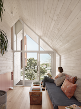 Off-the-shelf tongue-and-groove pine siding was used for the walls and ceiling. Vaulted spaces make the small footprints feel larger. 