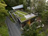 The green roof’s dramatic slope is supported by a mesh-and-soil planting system by SOPREMA. Landscape architect Marie-Ève Parent of Lemay did the landscape design. The original house is visible beyond. 