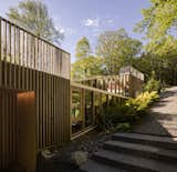 The slope of the roof mirrors the surrounding landscape. Windows are placed to catch the breeze. 