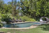 Outdoor, Swimming Pools, Tubs, Shower, Back Yard, Grass, Garden, Trees, and Shrubs Lagoon Style Peeble Sheen Pool  Search “lagoon” from Balinese Modern in Encino