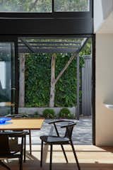 Dining Room, Chair, Light Hardwood Floor, and Table Dining space thru to rear garden  Photo 6 of 30 in South Yarra Void House by Andrew Child