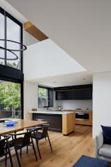 Dining Room, Chair, Table, Recessed Lighting, Light Hardwood Floor, Pendant Lighting, and Ceiling Lighting Void above Dining space  Photo 7 of 21 in Thanks to a Double-Height Dining Room, a Melbourne Home Basks in Sunshine and Courtyard Views from South Yarra Void House