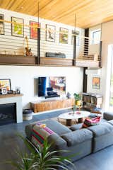 Living Room, Sectional, Ceiling Lighting, Porcelain Tile Floor, and Gas Burning Fireplace Living room with loft above  Photo 7 of 15 in Venice Beach Canals home by Verdego Design, LLC