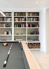 Living Room, Table, Ceramic Tile Floor, and Bookcase Pool table  Photo 5 of 14 in H House by STUDIO OCRA