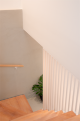 Staircase, Wood Railing, and Wood Tread Stairs detail. The slots seamlessly extend from the bespoke millwork above, establishing a cohesive visual connection across the entire wall.  Photo 4 of 10 in Bed-Stuy Duplex by STUDIO OCRA