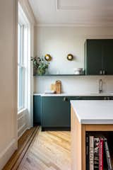 The kitchen was designed to be open and welcoming, with details such as an open shelf and sconces.