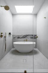 Bath Room, Full Shower, Ceramic Tile Wall, Freestanding Tub, Mosaic Tile Wall, and Stone Slab Wall The primary bathroom includes a wet area which accommodates both a freestanding tub and the large shower.  Photo 12 of 18 in Bergen Townhouse by STUDIO OCRA