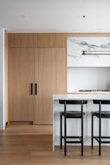 One of the cabinet doors cleverly conceals a passage to the apartment’s service area, here a view of the door close. 
