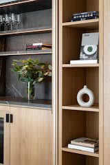 A close-up of the dining area cabinetry, showcasing the dry bar and integrated shelf.