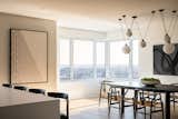 A corner window brings natural light into the dining area, framing breathtaking views of the city and the East River.