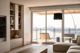 From the living room sofa, the breathtaking view of the East River brings a sense of calm while overlooking the urban skyline.