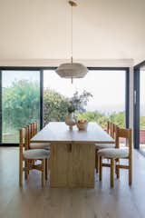 Dining Room, Table, Chair, Pendant Lighting, and Light Hardwood Floor  Photo 10 of 15 in Ocean Views For Days by Katie Betyar