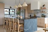 Kitchen, Wood Cabinet, Range, Refrigerator, Stone Slab Backsplashe, Light Hardwood Floor, Pendant Lighting, Undermount Sink, and Marble Counter  Photo 12 of 15 in Ocean Views For Days by Katie Betyar