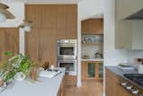 Kitchen, Colorful Cabinet, Light Hardwood Floor, Range, Marble Counter, Quartzite Counter, Wood Cabinet, and Pendant Lighting  Photo 4 of 18 in So Rad in Carlsbad by Katie Betyar