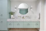 Sherwin Williams' Fresh Eucalyptus green is paired with terrazzo countertops to create a whimsical kids' bathroom. 