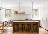 The kitchen tiles are by Heath Ceramics with barstools by March SF and pendant lights by Allied Maker.