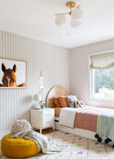 Amelia's room&nbsp; features a hidden horse motif wallpaper by Cavern Home with bold equestrian art and a pouf by Clic.