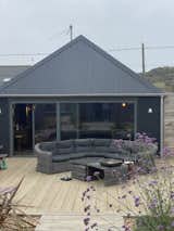 The back-deck of Lark Rise, with its inviting lounge space and warm, weathered scaffolding floors.