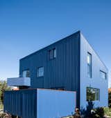 A Blue House Clad With Corrugated Steel Blends Into the Scandinavian Sky