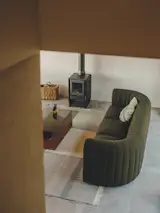 <span style="font-family: Theinhardt, -apple-system, BlinkMacSystemFont, "Segoe UI", Roboto, Oxygen-Sans, Ubuntu, Cantarell, "Helvetica Neue", sans-serif;">A view of the lounge from the stairs reveals the couple's wood stove, which is perfect for peak demand.</span>