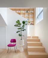 Built-in shelving and integrated storage, like in this wall up the stairs, imbues Mouse House with layers of porosity.