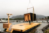 The commissioned project was the first sauna and floating design of its kind for Aux Box. Here, the sauna is craned into place, just like how the company installs backyard offices or yoga studios.