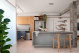 The open kitchen boasts a burnt-cement floor with a playful pink pigmentation, which the architect and Flavia collaborated on together.