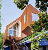 One of the smallest homes on record for the AIA Austin Homes Tour, this 660-square-foot studio space was built from corrugated Cor-Ten steel with a cantilevered construction that was designed to fit above the existing roofline, while preserving the backyard.