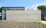 <span style="font-family: Theinhardt, -apple-system, BlinkMacSystemFont, "Segoe UI", Roboto, Oxygen-Sans, Ubuntu, Cantarell, "Helvetica Neue", sans-serif;">A monolithic concrete wall acts as not only as a street-front enclosure, but also a threshold, and a deliberate transition from public to private life.</span>