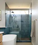 "I love everything about our primary suite—the giant blackout curtains that swoosh just right when you open them to let the morning sun in through the big windows or close them to turn the world off at night,