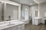 Bath Room, Engineered Quartz Counter, Ceiling Lighting, Undermount Sink, Porcelain Tile Wall, Accent Lighting, Porcelain Tile Floor, Two Piece Toilet, and Undermount Tub  Photo 9 of 13 in Emory Oak Drive Residence by Darren Heine