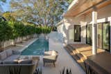 Outdoor, Back Yard, Trees, Swimming Pools, Tubs, Shower, Shrubs, Stone Patio, Porch, Deck, Concrete Fences, Wall, and Decking Patio, Porch, Deck Pool Deck  Photo 17 of 32 in The Sanger Residence by Open Workshop for Architecture