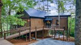 The 1.38-acre hilltop lot in Cherry Log, GA, could provide inspiring vistas… if not for the high, obstructive tree line. 

The selected architectural design firm and client collaborated tirelessly to create a solution. Finally, they landed on a concept that would elevate the home above the ground and even incorporate the surrounding Georgia hardwoods into the design.